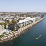 Drone image of the Portofino Hotel & Marina with a kayaker in the bay.